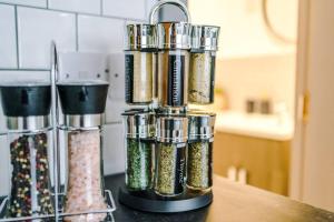 a spice dispenser sitting on top of a counter at Elegant & Comfortable 1-BR Flat by Amazing Spaces Relocations Ltd in Warrington