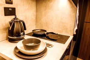 a kitchen counter with a tea kettle and plates on it at Superior 1 Bed Studio 3D near Royal Infirmary & DMU in Leicester