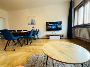 a living room with a table and chairs and a tv at Apartmán č.5 v bankovním domě in Kutná Hora