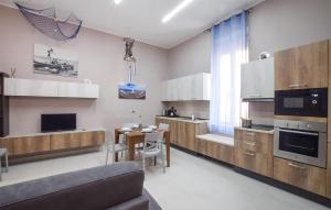 a kitchen with a couch and a table in it at Gorgeous Home In Reggio Calabria With Kitchen in Reggio di Calabria