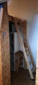 a wooden ladder in a room with a book shelf at Cosy 4p Loft & CoWorking space 5m walk to ski lift in Briançon