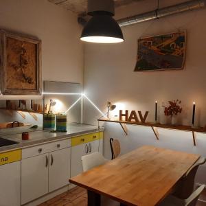 a kitchen with a wooden table and a dining room at Cosy 4p Loft & CoWorking space 5m walk to ski lift in Briançon