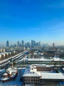 a city with snow covered buildings and a city skyline at SKY TOWER APARTMENTS in Warsaw