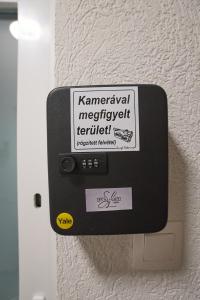 a switch on a wall with a sign on it at Sunlight Grey Szeged - Exclusive in Szeged