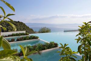 a swimming pool with a view of the ocean at Cora Hotel & Spa in Afitos