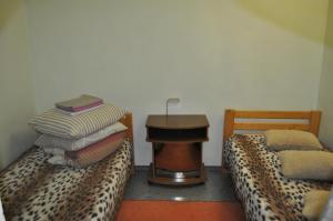 a room with two beds and a table with a leopard print at DayFlat Apartments Kremenchug in Kremenchuk