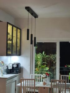 a kitchen with a table and chairs and a window at Serene Home Stay in Bangalore