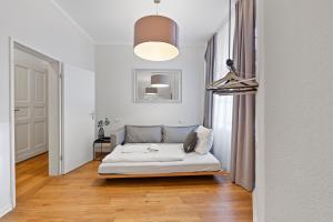 a bedroom with a bed in a room with a window at primeflats - Big family apartment Schöneberg in Berlin