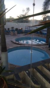 two swimming pools with the ocean in the background at VILLA DEL SOL Hotel in Fortaleza