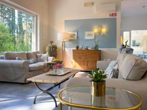 a living room with two couches and a coffee table at Hotel Brigantino in Procchio