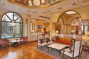 Heritage Village Resort & Spa Manesar-Gurgaon في جورجاون: غرفة معيشة مع أريكة وكراسي