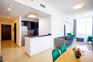 a kitchen and living room with a table and chairs at Modern Sea View 1Bedroom Dubai Marina in Dubai