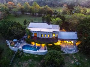 an aerial view of a house with a swimming pool at The Good Earth Farm in The Crags +22 photos