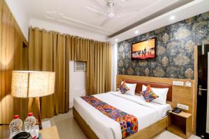 a hotel room with a bed and a lamp at Hotel Ink Haven Near Delhi Airport in New Delhi