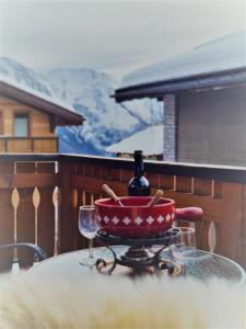 a table with a bottle of wine and two glasses at First : ski-out for 4 in the central Chalet Diana in Bettmeralp