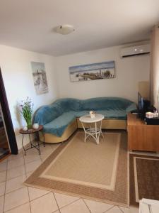 a living room with a couch and a table at Haus Sunny in Vrsi