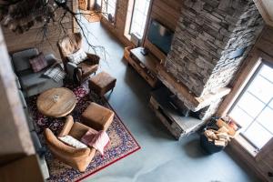 an overhead view of a living room with a stone fireplace at Luxurious cottage with sauna overlooking mountains in Vemdalsskalet