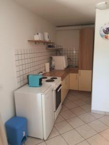 a small kitchen with a stove and a refrigerator at Haus Sunny in Vrsi +5 photos