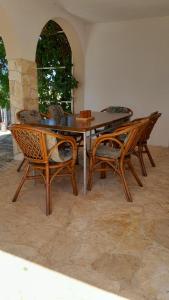 a wooden table and chairs in a room at Haus Sunny in Vrsi