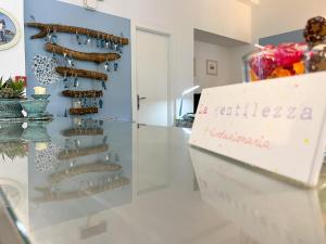 a display case with wine bottles in a room at Hotel Brigantino in Procchio