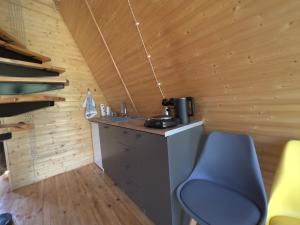 a small kitchen with a blue chair in a cabin at Focus Point Drakhtik - Green Cabin in Drakhtik +18 photos