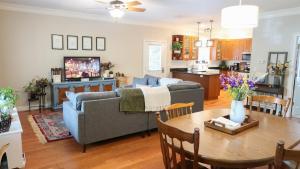 a living room with a couch and a table at Cozy Artist's Cottage-3br, Dt, Uga, Classic Cent in Athens