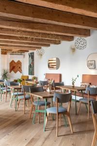 a dining room with wooden tables and chairs at Pipitér Rooms & More in Szigliget