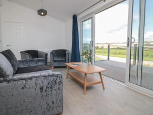 a living room with a couch and a table at Buttercup Lodge in Dartmouth