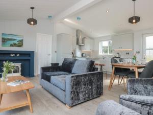 a living room with a couch and a table at Buttercup Lodge in Dartmouth