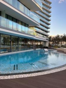 a swimming pool in front of a building at WAVE 10th Floor Baltic View in Międzyzdroje