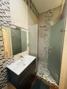 y baño con lavabo, ducha y espejo. en 7Seven Apartament, en Málaga