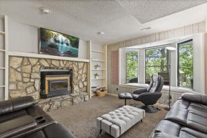 a living room with a couch and a fireplace at 6bedrooms, ramp boat dock slips water toys, nice cove area in Linn Creek