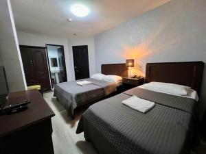 Postel nebo postele na pokoji v ubytování Hotel Capada