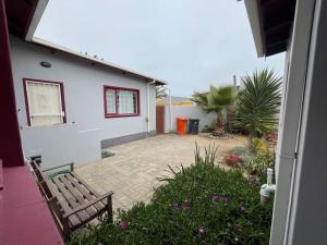 a house with a bench in front of a yard at Beachwalker 52 in Swakopmund