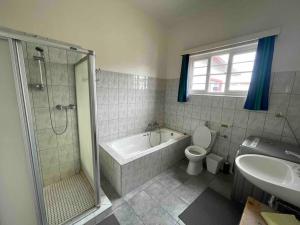 La salle de bains est pourvue d'une baignoire, de toilettes et d'un lavabo. dans l'établissement Beachwalker 52, à Swakopmund
