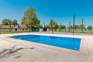 a swimming pool in the yard of a house at Napfény Resort by HelloBalatonlelle in Balatonlelle