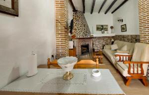sala de estar con sofá y chimenea en Cozy Home In Benalaureia With Kitchen, en Benalauría