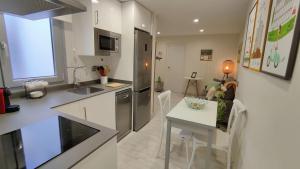 a kitchen and dining room with a table and a kitchen and a kitchen at APARTAMENTO LA UNIÓN in Castellón de la Plana