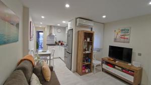 a living room with a couch and a kitchen at APARTAMENTO LA UNIÓN in Castellón de la Plana