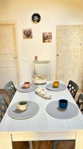 a table with three cups and plates on it at Casa vacanze profumo di mare in Fiumicino