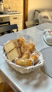 a basket of bread sitting on top of a table at Casa vacanze profumo di mare in Fiumicino