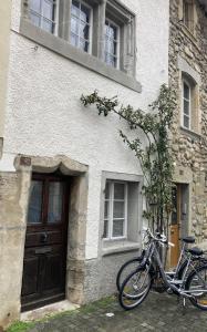 a bicycle parked in front of a building at "La Petite Rochette" in Estavayer-le-Lac