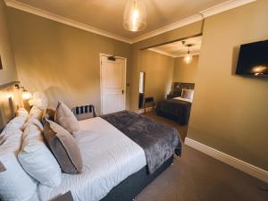 una camera d'albergo con letto e TV di The Kings Arms a Swindon