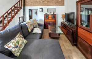 a living room with a couch and a tv at Nice Home In Barbate With Wi-fi in Barbate