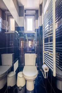 a bathroom with a toilet and a sink and a tub at Charming 2BDR Apartment in Historic Center With Parking in Sofia +18 photos