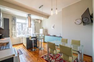 a kitchen with a table and chairs in a room at Charming 2BDR Apartment in Historic Center With Parking in Sofia