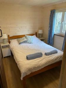 a bedroom with a bed with two pillows on it at Idyllic Cornish Retreat At Puffin Lodge in Helston