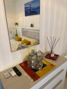 a table with a mirror and a box on a counter at Antonella home b&b in Bari