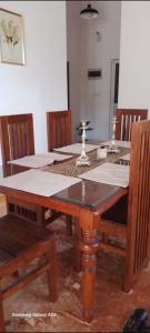 a dining room table with chairs and a table at White villa resort dodangoda in Kalutara