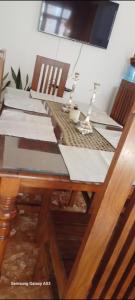 a dining room table with a wooden table and chairs at White villa resort dodangoda in Kalutara